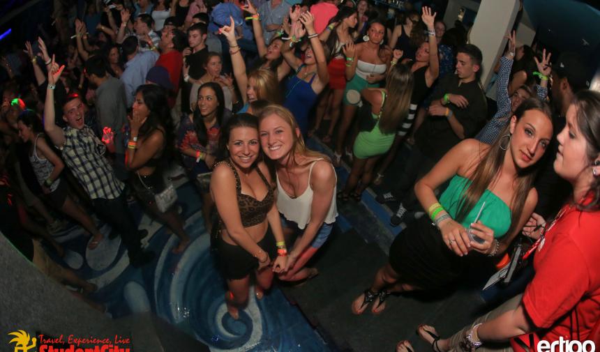 2 high school girls posing in a crowd during their Spring break trip to Nassau