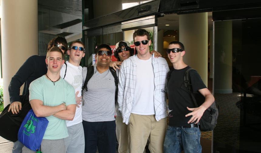 a group of high school students posing for a photo outside of their hotel in Nassau, Bahamas