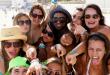 high school students pointing at the camera while on the beach in Riviera Maya